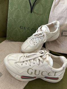 Elevate your shoe game with these Gucci Rhyton Leather Logo sneakers in size 8. The iconic design features a leather upper with the brand's signature logo, perfect for adding a touch of luxury to your casual outfits. These athletic shoes are specifically made for women and are sure to make a statement wherever you go. The Gucci Rhyton model is part of the brand's product line and is perfect for those who want to show off their fashion-forward style. Whether you're running errands or going out with friends, these sneakers are a perfect choice. So why wait? Add these Gucci Rhyton sneakers to your shoe collection now! ****Includes box, paper bag, 2 gucci drawstring bag. Only used once. Style ‎528892 DRW00 9522 Designed with a thick sole and bulky construction, the sneaker has a retro influenc Gucci Rhyton Sneakers, Gucci Rhyton, Box Paper, Iconic Design, Leather Logo, Vintage Logo, Signature Logo, Shoe Game, Low Heels