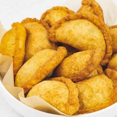 some fried food in a white bowl on a table