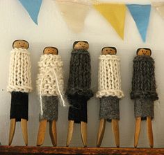 five wooden dolls are lined up on a shelf