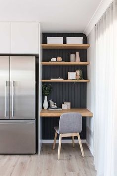 a kitchen with black and white walls, wood flooring and shelves on the wall