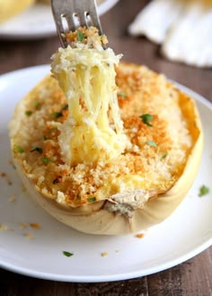 a fork is stuck into an eggplant stuffed with cheese and parmesan