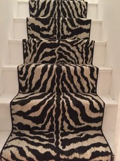 a set of stairs with zebra rugs on them