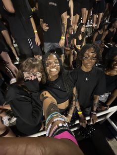 group of people posing for the camera in front of a crowd