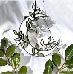 a circular metal object with green leaves on it