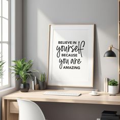 a desk with a computer and some plants