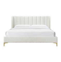 the bed is made with white linens and wood legs, but it has no headboard