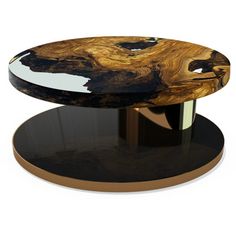 a black and gold coffee table sitting on top of a wooden stand