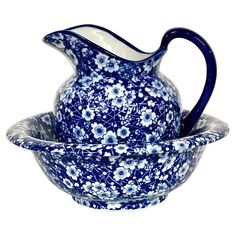 a blue and white flowered pitcher and bowl