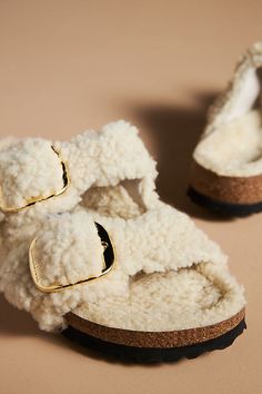 Teddy shearling upper, insole Cork-latex sole Slip-on styling Imported | Arizona Big Buckle Teddy Sandals by Birkenstock in Beige, Women's, Size: 37, Shearling/Cork-Latex at Anthropologie Shearling Open Toe Sandals With Removable Insole, Shearling Sandals With Faux Fur Lining And Round Toe, Round Toe Sandals With Faux Fur Lining In Shearling, Winter Shearling Sandals With Round Toe, Shearling Birkenstock Outfit, Fuzzy Birkenstocks, Shearling Birkenstock, Birkenstock Arizona Big Buckle, Faux Fur Sandals