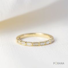 a gold ring with three baguettes on it