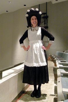 a woman dressed in an apron and hat