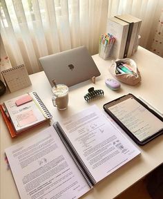 an apple laptop computer sitting on top of a desk next to a cup of coffee