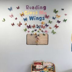 the children's bookshelf has many butterflies on it and is decorated with words reading gives me wings