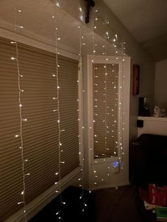 a room with some lights on the wall and blinds in front of it that are closed