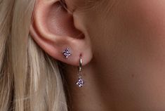 ✨This Flower Huggie Hoop Earring Set features dainty purple earrings, perfect for everyday ear stacks and designed as an elegant gift set of sterling silver jewelry tailored for women. This versatile set of earrings can be worn to elevate the look of a minimalist everyday outfit but is also great for any occasion. You will be able to mix and match it in different ways without getting tired of it. :)  ✨PURCHASE INCLUDES:  * 2 Pairs of Earrings (4pcs) ✨Product specifications:  * Material: Sterling silver with Zircon  * Hoops Diameter (inner): 7mm.  * Hoops width: 2mm. *Stud: 4mm. ✨ Packaging and Gifts:  * All pieces of jewellery are packed to be gift-ready in a cute pouch. I will gladly include a gift message. ✨Shipping:  * All orders will be shipped out within 1 business day by Royal Mail t Ear Stack, Silver Jewellery Sets, Hoop Earring Sets, Purple Earrings, Huggie Hoop Earrings, Delicate Earrings, Floral Earrings, Elegant Earrings, Gorgeous Earrings