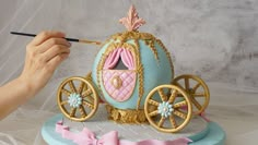 a cake that is shaped like a princess's carriage and has a brush in it