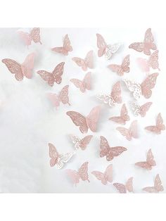 pink and white butterflies are flying in the air