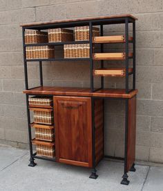 a wooden shelf with baskets on it next to a brick wall