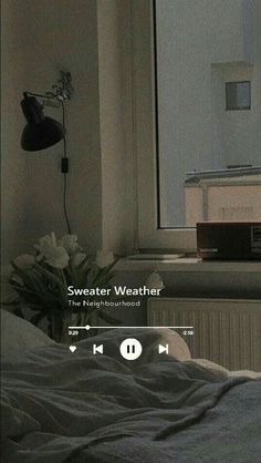 an image of a bed with the sound player on it's headboard in front of a window