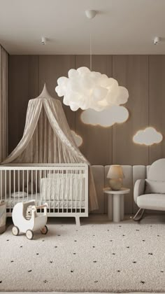 a baby's room with a crib, rocking chair and cloud shaped light fixture