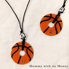 two orange and black basketball necklaces with numbers on them