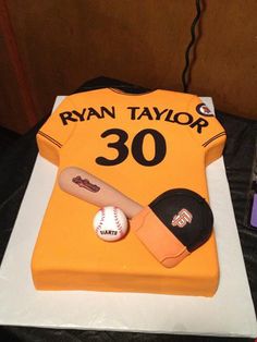 a cake that is shaped like a baseball jersey and hat, with the number 30 on it