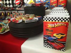 a table topped with lots of different types of toy cars and race cars on top of each other