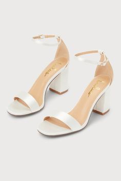 You're certain to step up your style essentials when you add the Lulus Arylee White Satin Ankle Strap Heels to your closet! Sleek satin shapes a single toe strap, an almond-shaped toe bed, and a wrapped block heel. A dainty ankle strap rises from the sturdy heel cup and secures with a gold buckle. 3" Wrapped Block Heel. Cushioned Insole. Felted Rubber Sole Has Nonskid Markings. Man Made Materials. Imported. Lulus | Arylee White Satin Ankle Strap Heels | Size 9. White Lulus Heels, White Prom Shoes High Heels, Wedding Shoes Bride Simple, Cute Shoes With Dresses, Shoes To Go With White Dress, Cute Heels White, Quince Shoes Heels White, Cute Shoes For Prom, White Heels Stilettos