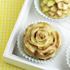 two cupcakes sitting on top of a white tray