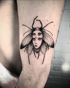 a woman with a bee tattoo on her leg