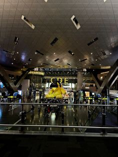 an airport lobby with people walking around