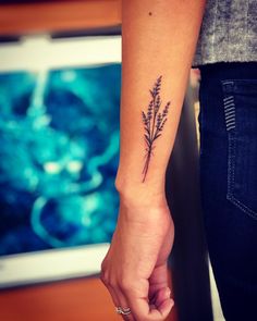 a woman holding the hand of a man with a tattoo on his arm that has a plant growing out of it