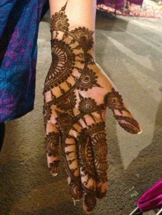 a woman's hand with henna on it