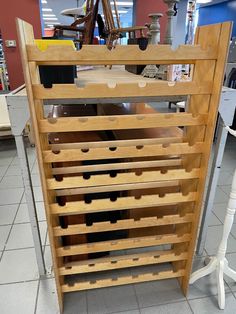 a wooden wine rack sitting on top of a tiled floor