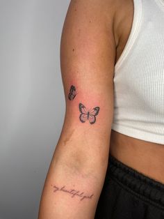 a woman's arm with two butterflies on it, and the word strength written in cursive writing