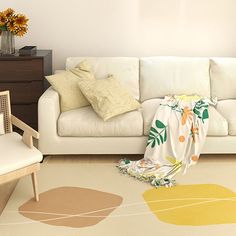 a living room with a white couch and yellow flowers on the floor next to it