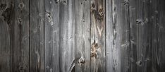 an old wooden wall with peeling paint on it