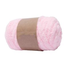 a roll of pink yarn sitting on top of a white surface