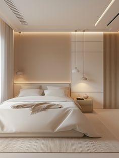 a large white bed sitting in a bedroom next to a wall mounted light above it