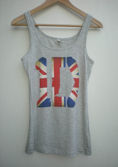 One Direction British Chic original Union Jack Tank Top original design. This is a super soft stretchy, very comfy Tank Top! Limited edition. Will not be reprinting. ♥ Sizes Ladies: S, M, L, XL, 2XL (pictured on hanger is a size small.) ♥ Color: Heather Gray ♥ Printed: Ink is infused onto garment making it softer to the touch.  Limited edition. Been wearing mine for years and it is still in very great condition. ♥ Style: Fitted stretchy, soft and comfy jersey knit. ♥ Fabric: Pre-shrunk 57% ring- Union Jack Outfit, Year 7, Grey Prints, Union Jack, Heather Gray, One Direction, Womens Tank, Original Design, Womens Clothing Tops