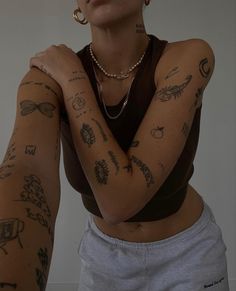 a woman with many tattoos on her arms