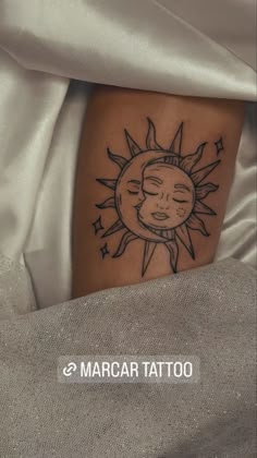 a sun and moon tattoo on the leg