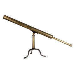 an antique brass telescope on a tripod