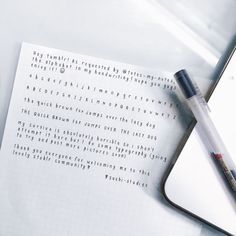 a notepad and pen sitting on top of an open notebook with the words written in cursive writing