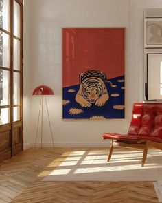 a room with a red chair and a painting on the wall