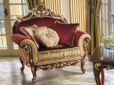 an ornately decorated living room with red and gold furniture