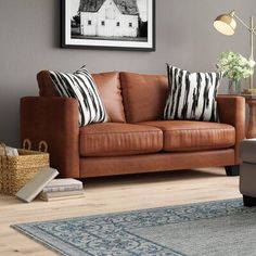 a living room with a brown leather couch