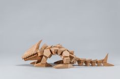 a wooden toy that looks like a dinosaur