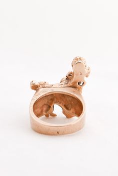 a gold ring with a dog on it