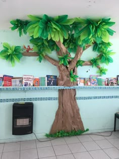 there is a paper tree in the middle of this room with books on the shelves